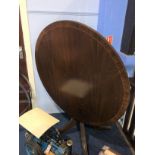 A reproduction mahogany circular table