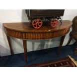 A reproduction mahogany demi-lune hall table, with crossbanded segmental top. 142cm wide