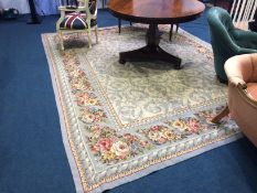 A French style carpet with ivory ground bearing all-over naturalistic floral design highlighted in