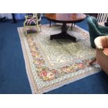 A French style carpet with ivory ground bearing all-over naturalistic floral design highlighted in