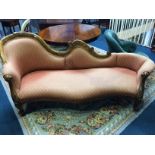 A Victorian mahogany scroll end settee