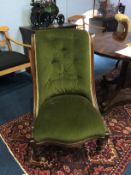 A mahogany nursing chair, with green upholstery