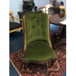 A mahogany nursing chair, with green upholstery