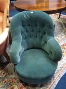 A blue upholstered button back armchair