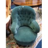 A blue upholstered button back armchair