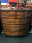 A 19th century bow front chest of drawers, with two short and three long graduating drawers,