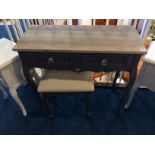 A modern grey side table and matching stool