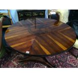 An Empire style rosewood circular centre table, with quarter top and parquetry centre and