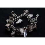 Silver charm bracelet with 18 charms