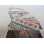 18 presentation packs of mint stamps