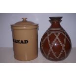 A stoneware bread bin together with a ceramic vase