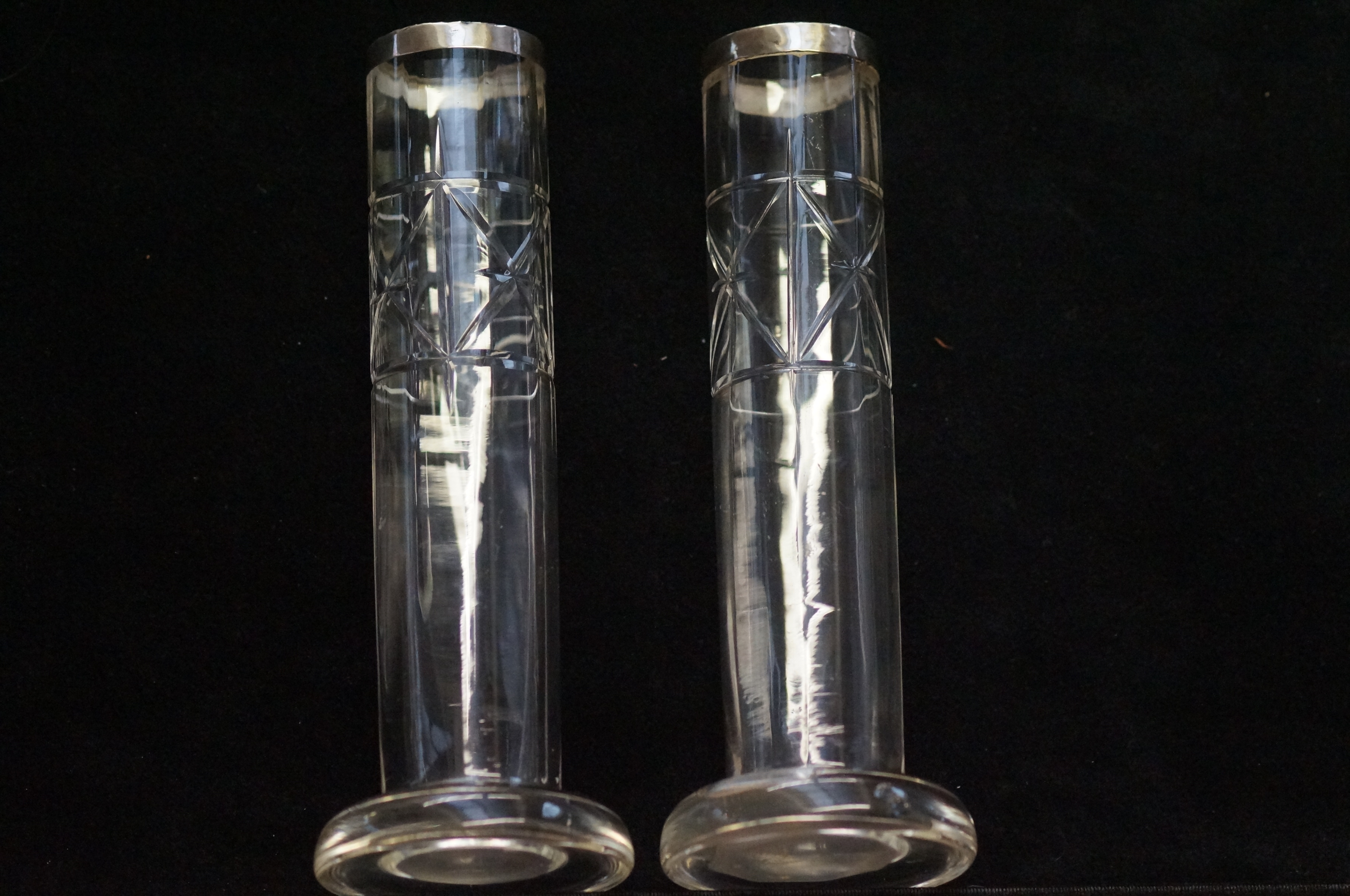 A pair of silver topped glass vases