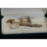 Silver tie clip together with gold on silver cuff