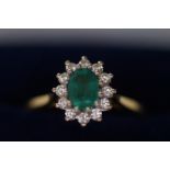 18ct gold ring set with emerald(?) and diamonds