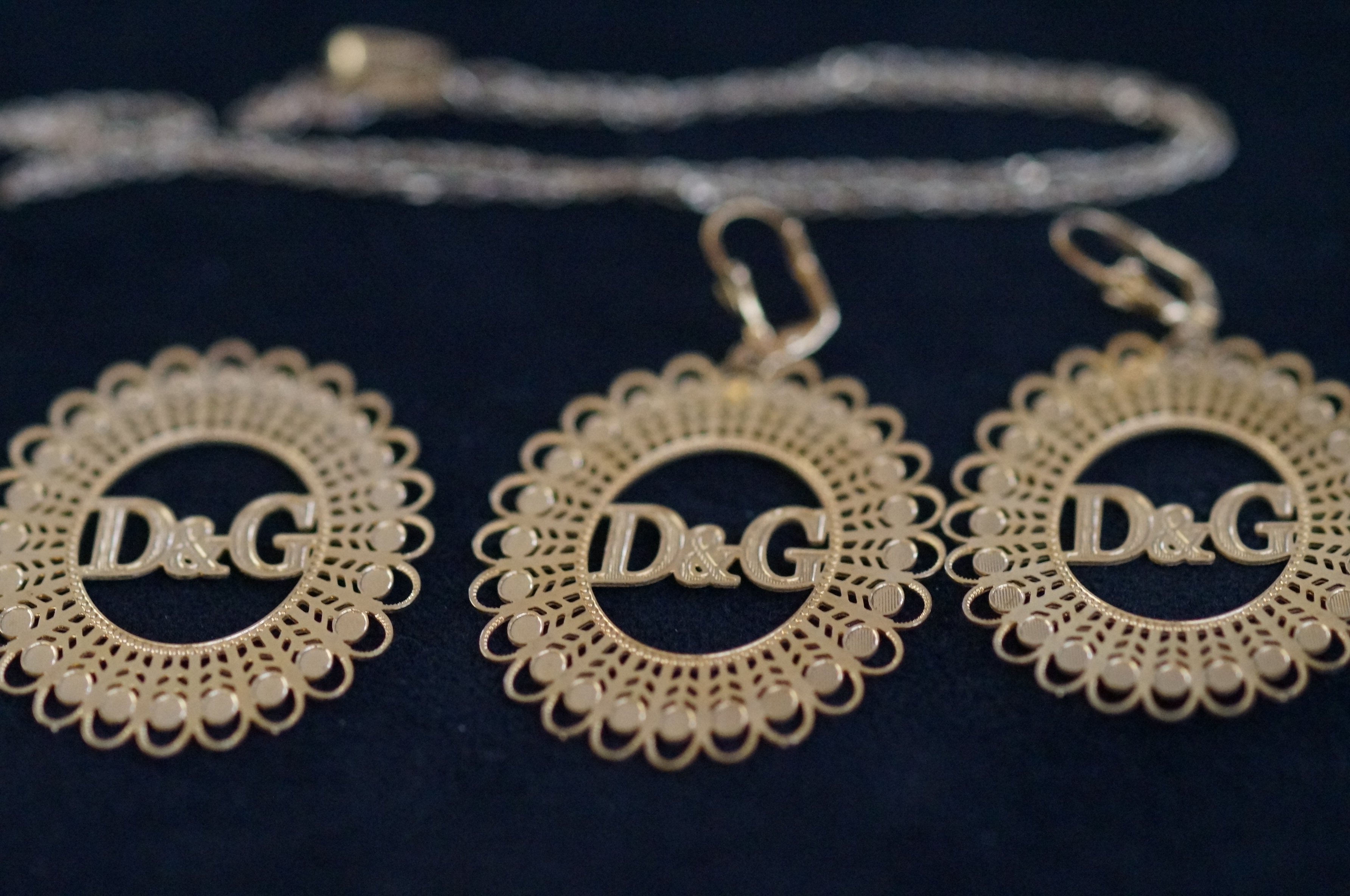 3 D&G Pendants together with a 9ct Gold Chain