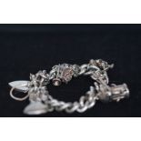 silver charm bracelet with 9 charms