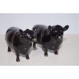 Beswick Aberdeen angus bull and cow, with gold bac