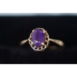 9ct gold ring set with purple stone