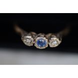 9ct gold ring set with 2 diamonds and one blue sto
