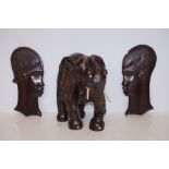 Carved African Elephant possibly Lignum together with Two Carved Wall Masks - Elephant is 27cm h