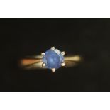 9ct Gold ring with light blue stone