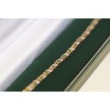 9ct Gold tennis bracelet set with emeralds & diamo