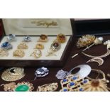 A collection of costume jewellery to include brooc