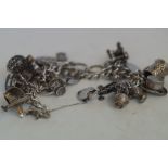 Silver charm bracelet with approx 24 charms