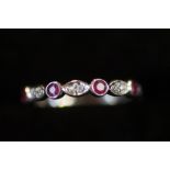 10ct White gold ring set with diamonds & ruby's Si