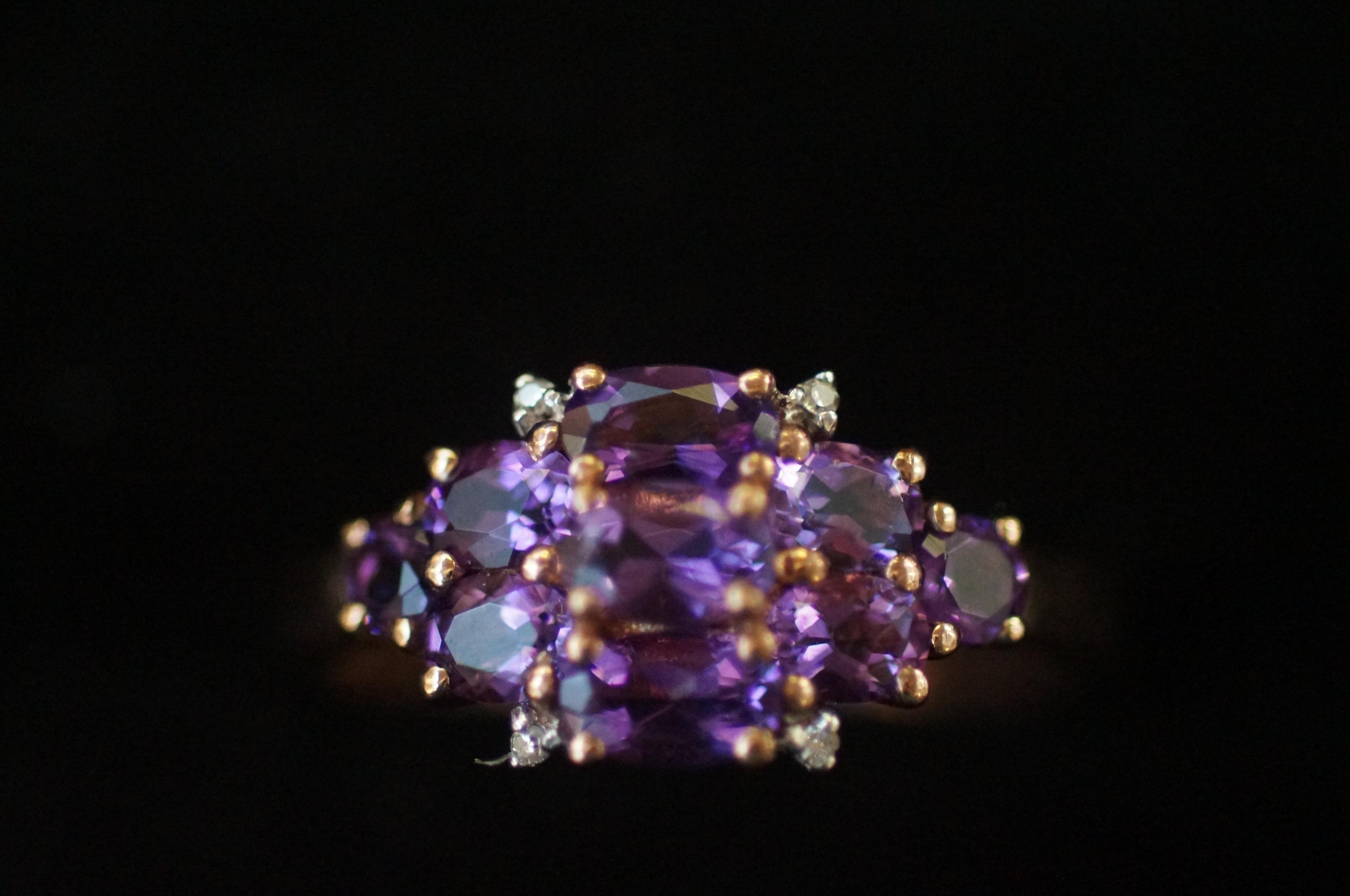 9ct Gold ring set with 9 purple stones