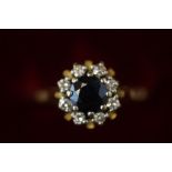 18ct Gold ring set with central sapphire surrounde