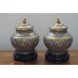 A pair of fine quality Cloisonné lidded vases on w