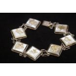 Silver Chinese bracelet with 7 links set with moth