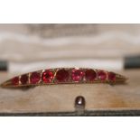 9ct Gold pin brooch set with 9 garnets