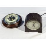 A bakelite clock and a small barometer