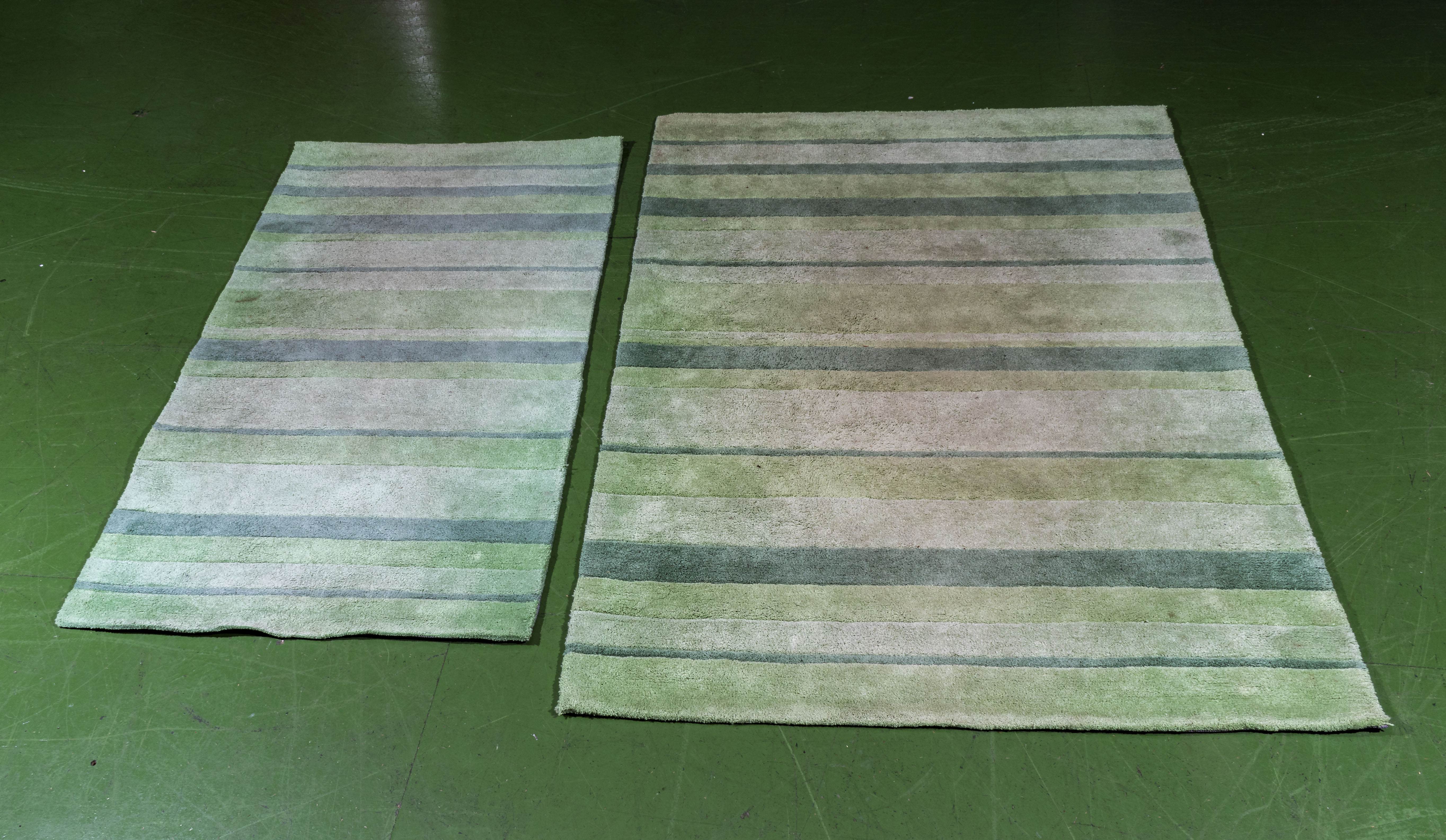 Two green striped rugs, 120cm x 180cm and 80cm x 150cm