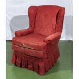 An upholstered wing back armchair