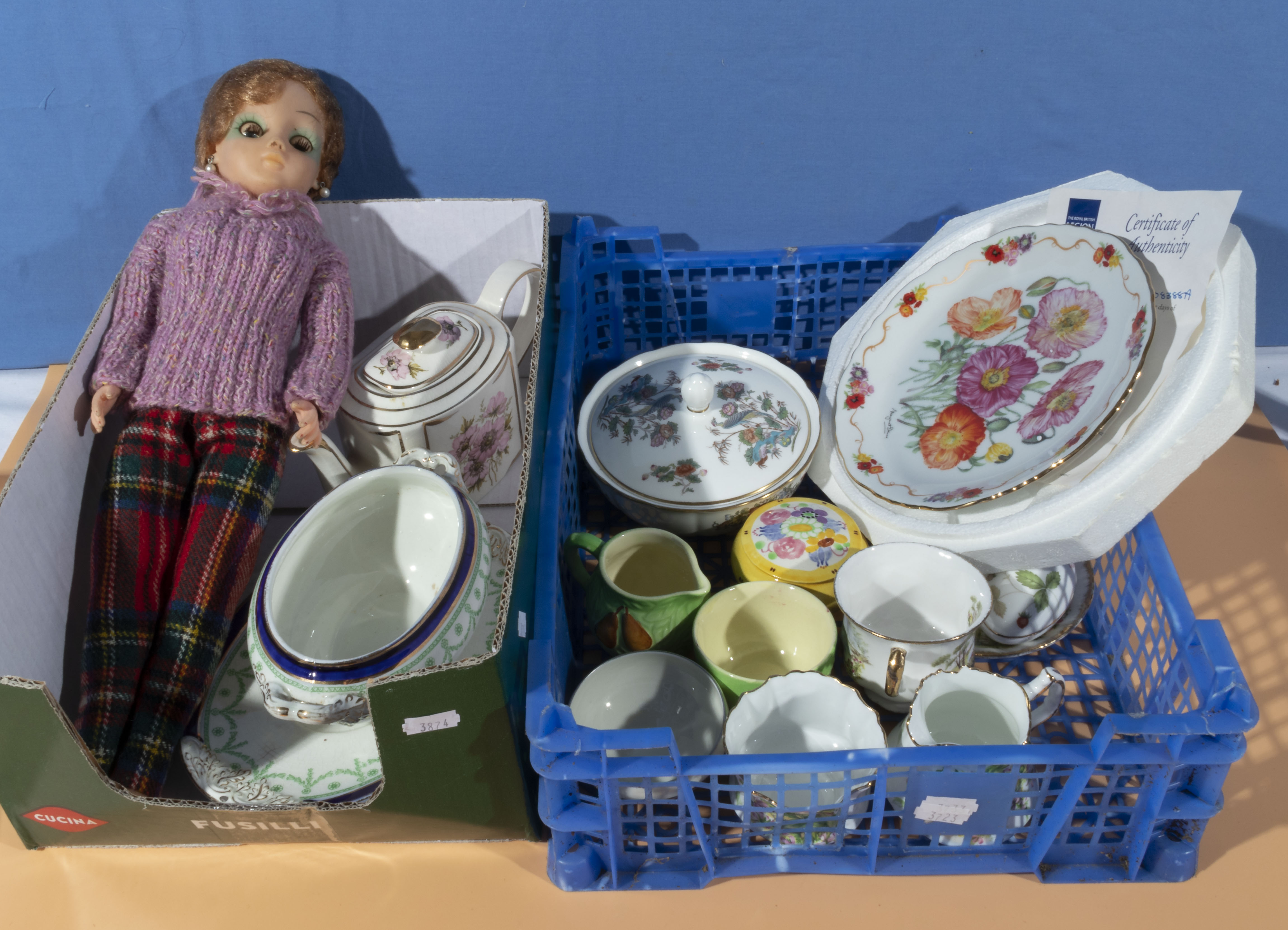 A box of china and a doll