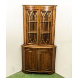 A 20th-century bow front corner cabinet, 1.8m tall and 92cm wide