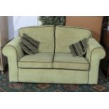 A pale green cord two seater sofa, matching lot 98
