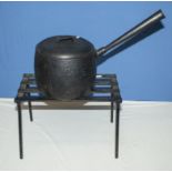 A cast saucepan and a trivet