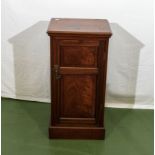 A mahogany bedside cabinet