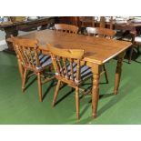 A pine kitchen dining table and four chairs, 148cm 78cm