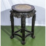 A Chinese carved stand with marble inserted top.