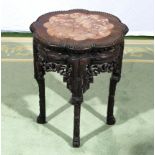 A Chinese carved stand with marble inserted top.