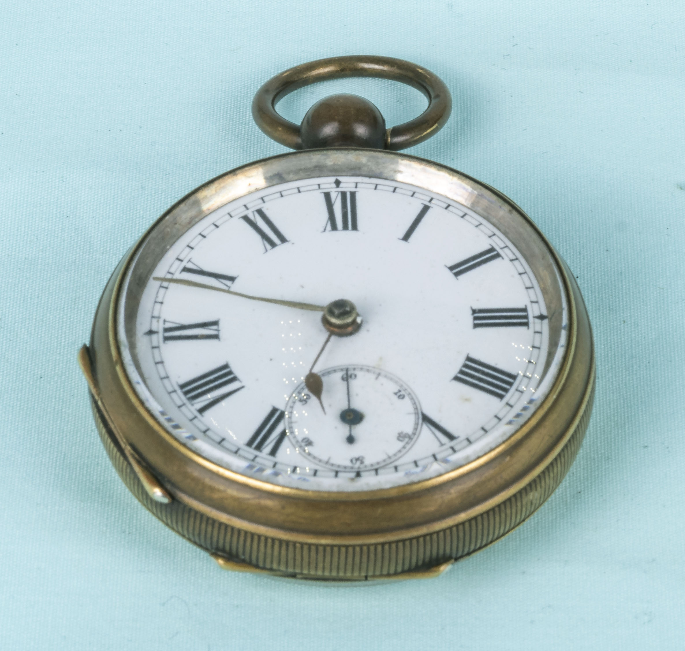 A large brass cased pocket watch