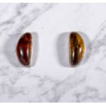 A pair of silver earrings set with amber