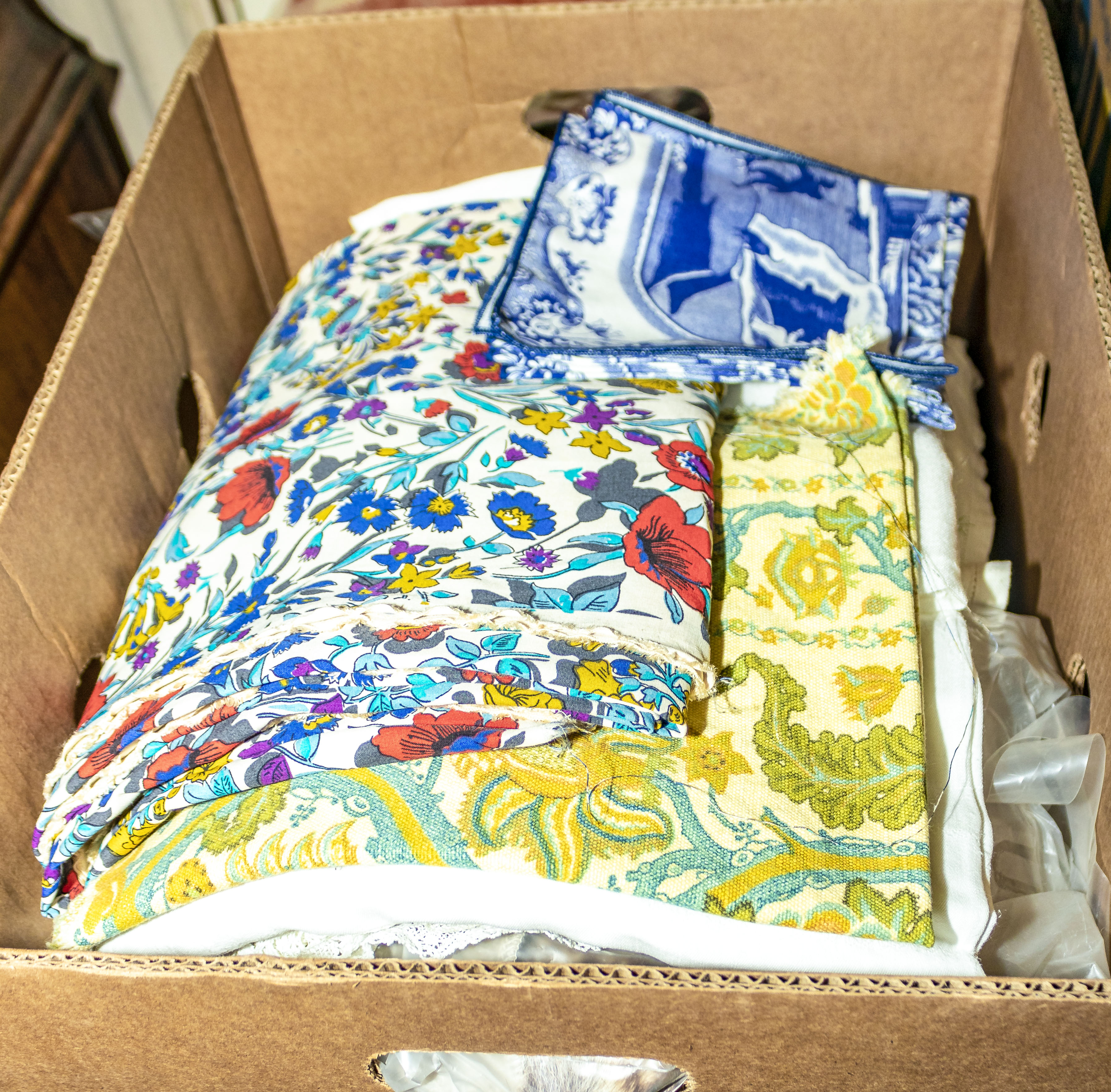 A box containing vintage linen and fabric
