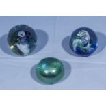 Three glass paperweights