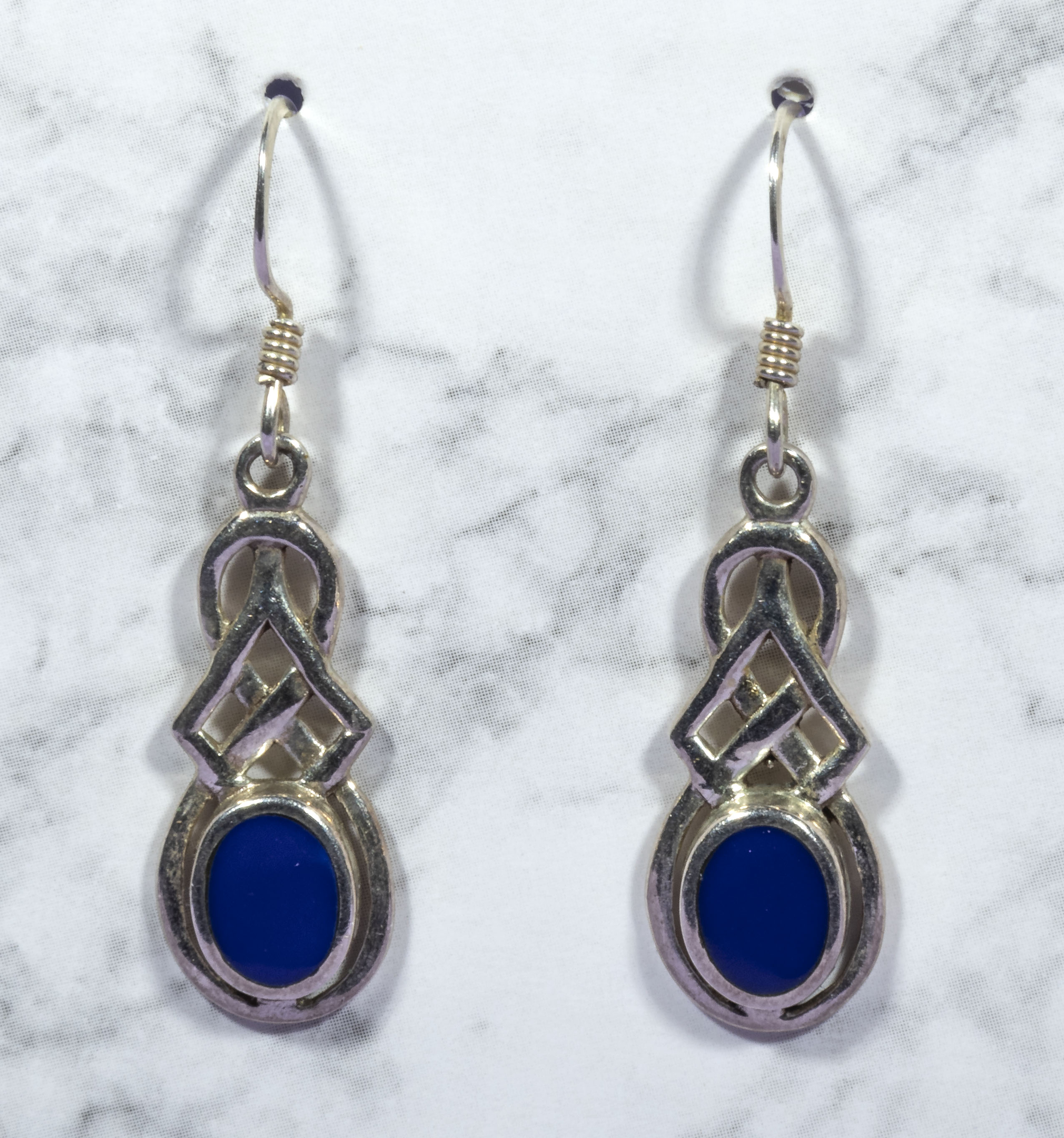A pair of silver dropper earrings set with blue stones